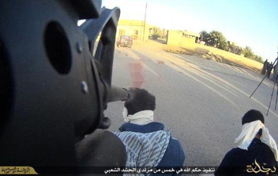 Spy executed in Islamic State. Notice they have attached cameras to their guns for horror photos.