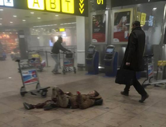 An injured man is seen at the scene of explosions at Zaventem airport near Brussels,